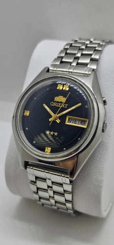 Relógio Orient 3 Estrelas Preto E Dourado Prateado Preto
